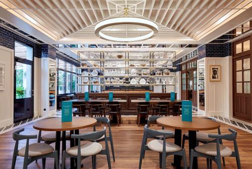 a restaurant with tables and chairs and a bar at Radisson Blu 1882 Hotel, Barcelona Sagrada Familia in Barcelona