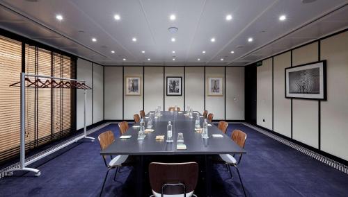 a large conference room with a long table and chairs at Radisson Blu 1882 Hotel, Barcelona Sagrada Familia in Barcelona