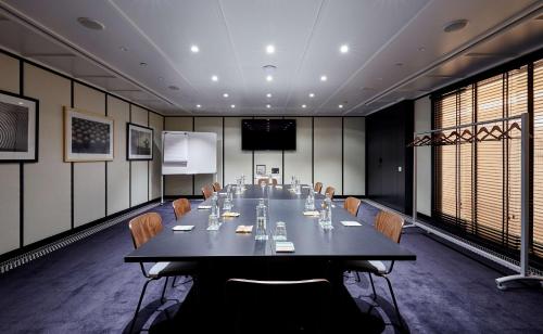 a conference room with a long table and chairs at Radisson Blu 1882 Hotel, Barcelona Sagrada Familia in Barcelona