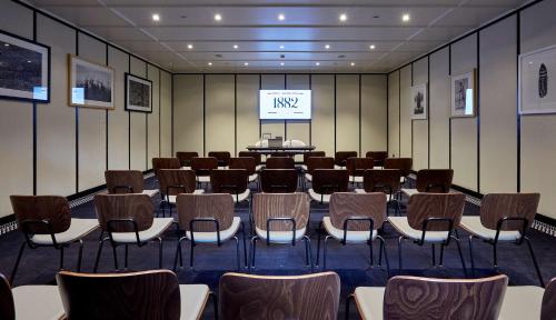 a conference room with a stage and chairs in it at Radisson Blu 1882 Hotel, Barcelona Sagrada Familia in Barcelona