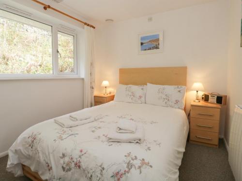 a bedroom with a large bed with two towels on it at Priory Ghyll in Windermere