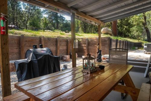 a wooden table in a room with a fence at Magic Escape in Oakhurst