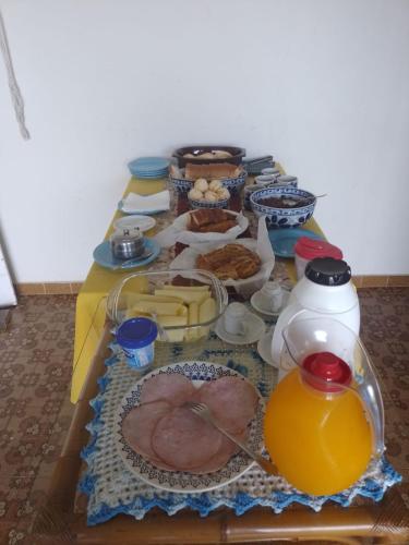 a table full of food and drinks on a table at hospedagens regina in Águas de Lindóia
