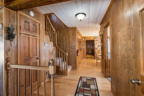 a hallway with wood paneled walls and a hallway with stairs at Tree Haven in Yosemite West