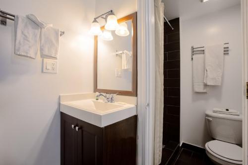 a bathroom with a sink and a mirror and a toilet at Star Route 66 Grand Canyon in Williams