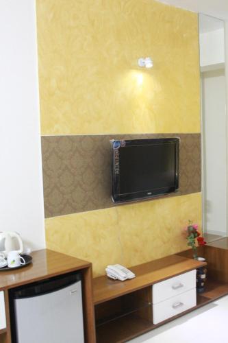 a room with a wall with a tv on the wall at NAAS Serviced Apartments in Dhaka