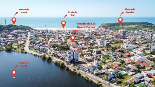 an aerial view of the city of kiama with red pointers at Parada da Cal Beach Torres in Torres