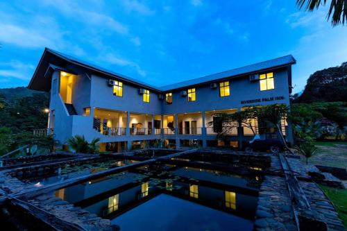 an exterior view of a house with a pool at RIVERSIDE PALM INN SG LEMBING in Sungai Lembing