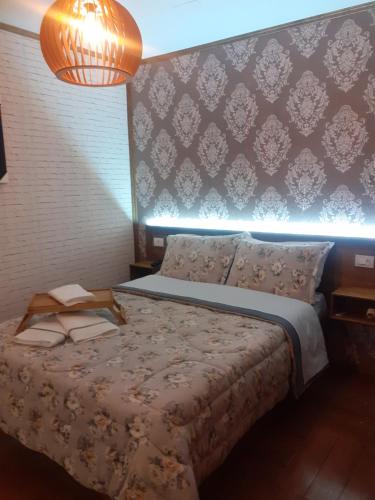 a bedroom with a bed with a lighted wall at Hospedagem Souza in Urubici