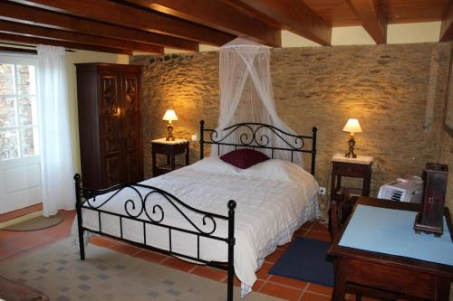 a bedroom with a bed and two tables with lamps at Casa do Moinho in Ovar