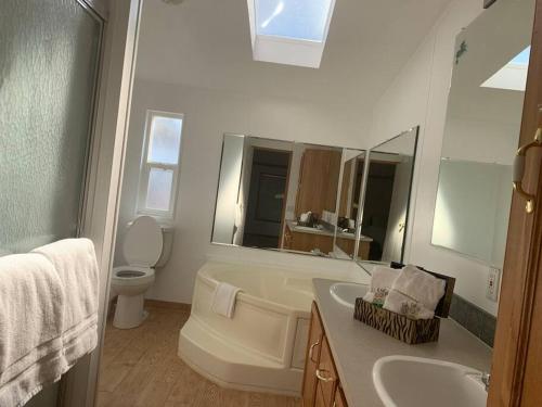 a bathroom with a sink and a toilet and a mirror at Views Views Views! in Wofford Heights