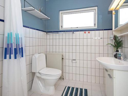 a bathroom with a toilet and a sink at 6 person holiday home in Nørre Nebel-By Traum in Nørre Nebel
