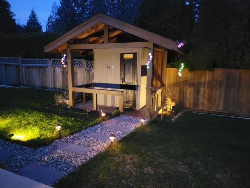 a backyard with a gazebo at night with lights at JoyVeal’s Homey Place in Sechelt