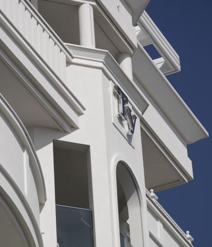 a white building with a window on the side of it at Hotel Tiffany's in Riccione