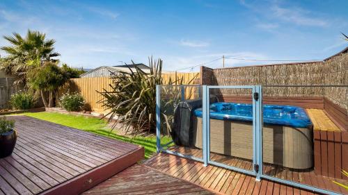 a hot tub sitting on top of a wooden deck at Sunderland Retreat in Sunset Strip