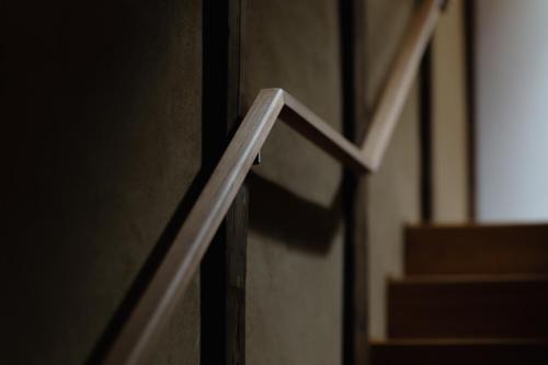 a close up of a wooden rail on a door at 滔々 阿知の庄 蔵の宿 toutou Achinosho Kura no Yado in Kurashiki