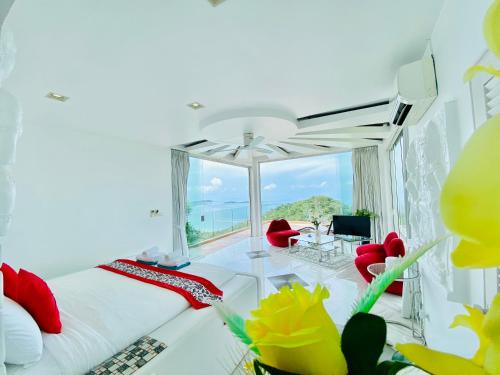 a bedroom with a bed and a view of the ocean at Best world vision in Chaweng