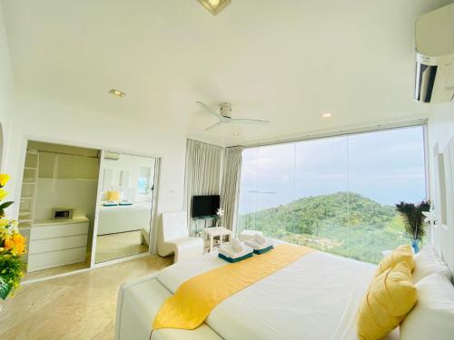 a bedroom with a large bed and a large window at Best world vision in Chaweng