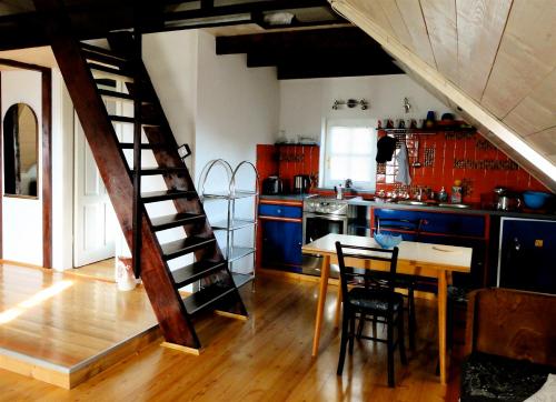 a kitchen with a wooden staircase and a table and chairs at Apartment Tagrajska in Ljubljana