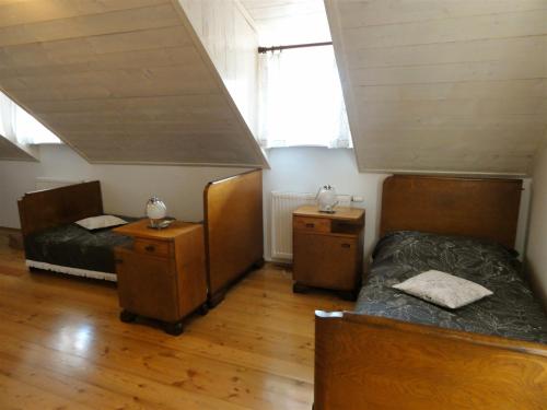 two beds and two night stands in a room at Apartment Tagrajska in Ljubljana
