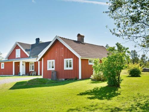 a red house with a green lawn in front of it at 6 person holiday home in LÅNGARYD-By Traum in Skeppshult