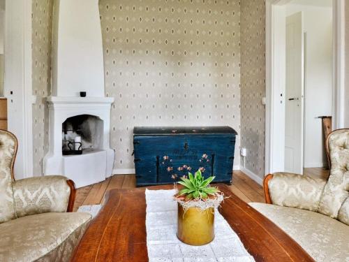 a living room with a table and a fireplace at 6 person holiday home in LÅNGARYD-By Traum in Skeppshult