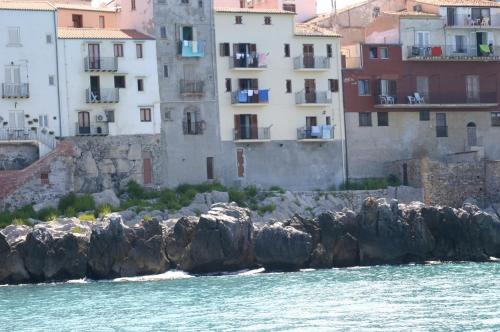a group of buildings on the shore of the water at MiraMare Residence Cefalú in Cefalù