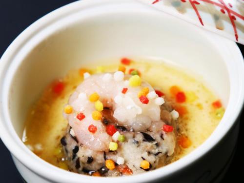 a white bowl filled with soup with popcorn and sprinkles at Amagiso in Kawazu
