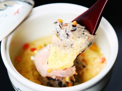 a piece of food in a bowl of soup at Amagiso in Kawazu