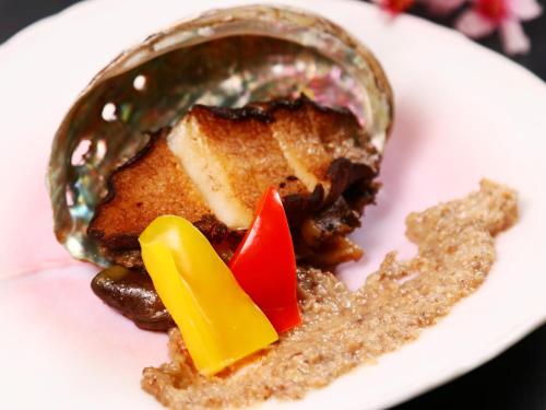 a white plate topped with a tablespoon of food at Amagiso in Kawazu