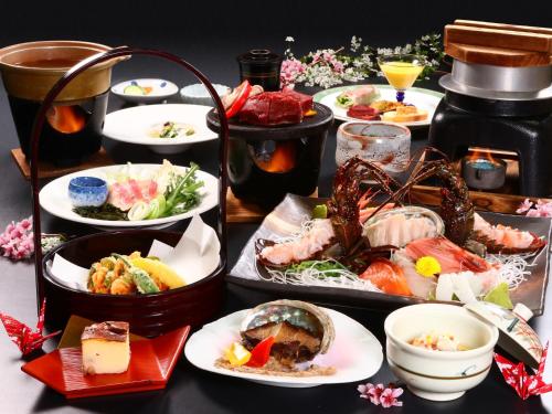 a table topped with different types of food on plates at Amagiso in Kawazu