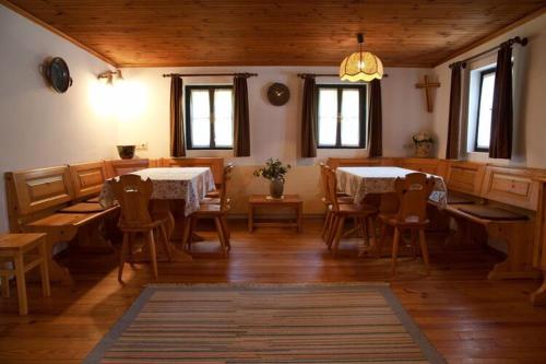 a dining room with two tables and chairs at Apartments Grafhube, Afritz-Verditz in Innere Einöde