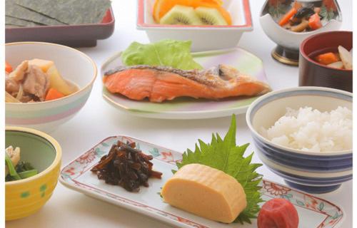 a table with plates of food and bowls of food at Tsubamesanjo Washington Hotel in Sanjo