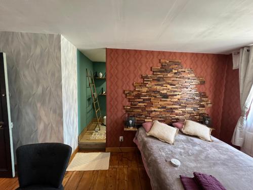 a bedroom with a brick wall and a bed at Chambre D'hôte Villa Maurice in Étretat