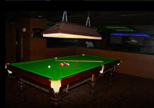 a green pool table with a ball on it at Sterling V Grand Madurai in Madurai