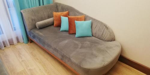 a couch with three pillows on it in a room at Henna Hotel Istanbul in Istanbul