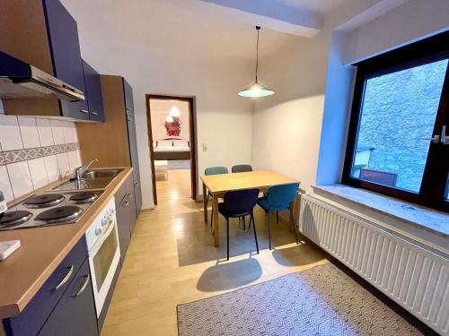 eine Küche mit einem Tisch und Stühlen sowie einem Fenster in der Unterkunft ARTAPART - Apartment Top 2 self check-in in Graz