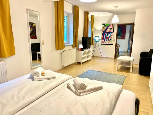 a bedroom with a bed and a living room at ARTAPART - Apartment Top 2 self check-in in Graz