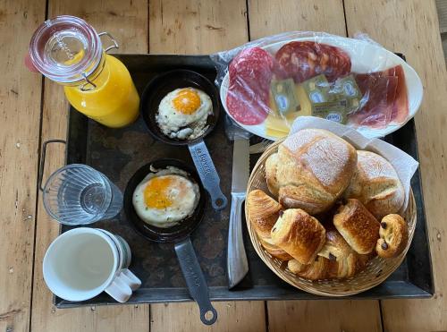 a tray of breakfast food with eggs and bread at Landgoed de Bongel in De Wijk