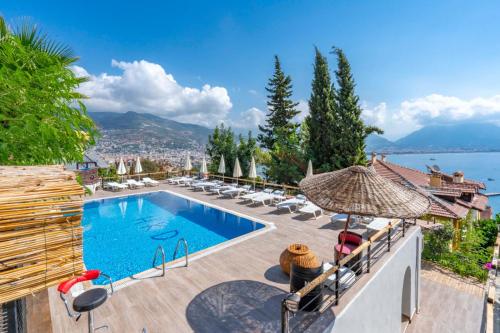 a villa with a swimming pool and a view at Castle Boutique Hotel Alanya in Alanya