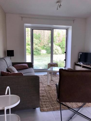 a living room with a couch and a table at Les 4 gites de la Saisse in Pont-de-Poitte