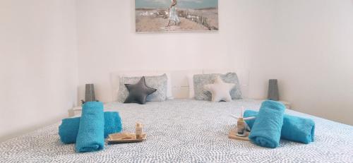 a bedroom with blue pillows and toys on a bed at CASA IVE ROMANTIC POOL in Caleta De Fuste