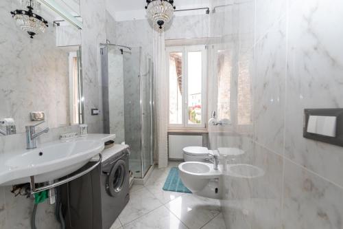 a bathroom with a sink and a toilet and a shower at Gastaldaga in Cividale del Friuli