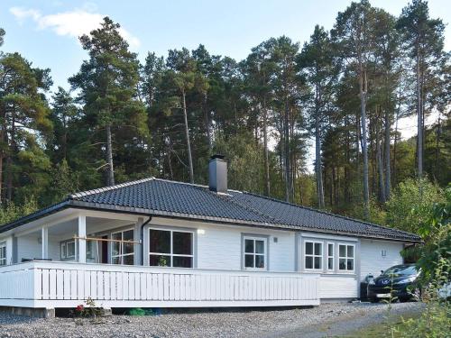 a white house with a car parked in front of it at 6 person holiday home in SANDANE-By Traum in Sandane