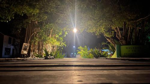 a street at night with a light in the background at Atholhu Residence in Fehendhoo