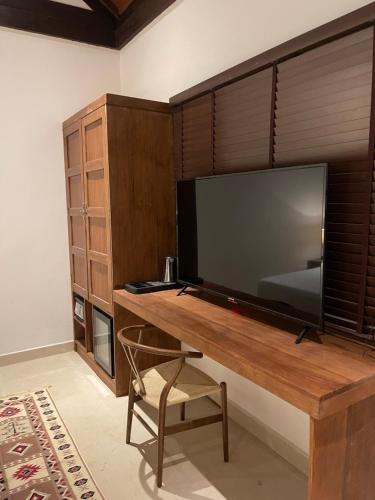 a room with a desk with a flat screen tv at Atholhu Residence in Fehendhoo