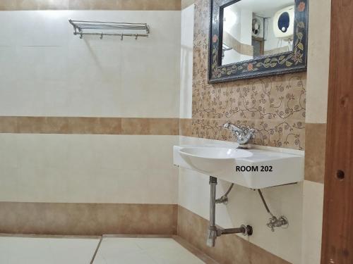 a bathroom with a sink and a mirror at Rigmor haveli in Jodhpur