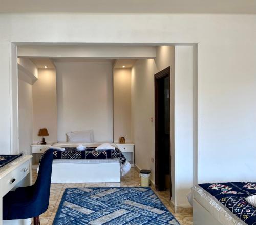 a bedroom with a bed and a desk with a chair at Pyramids top success result in Cairo