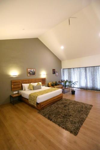 a bedroom with a large bed and a rug at Destiny - The Farm Resort in Ooty