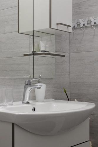 a bathroom with a white sink and a mirror at Rooms Zana in Split